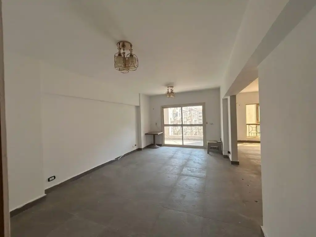 Spacious living room in a luxury Cairo apartment for sale in Al Baron Compound. Modern design with l.