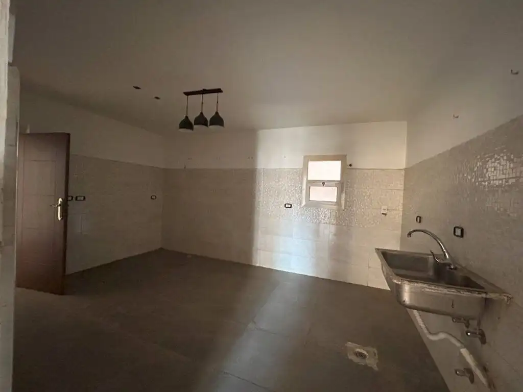 Spacious modern apartment in Cairo with kitchen and natural light.