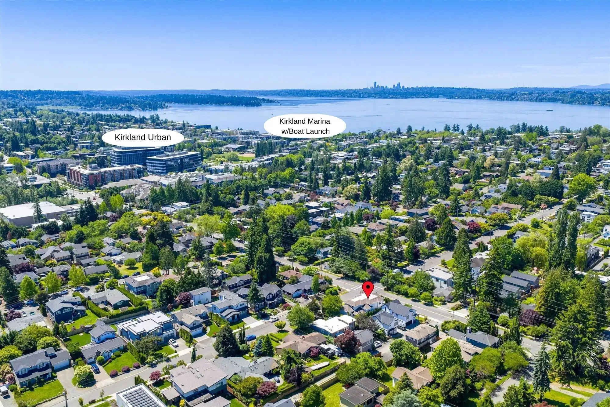 Elegant custom home overlooking Lake Washington in Kirkland, surrounded by lush greenery and vibrant.
