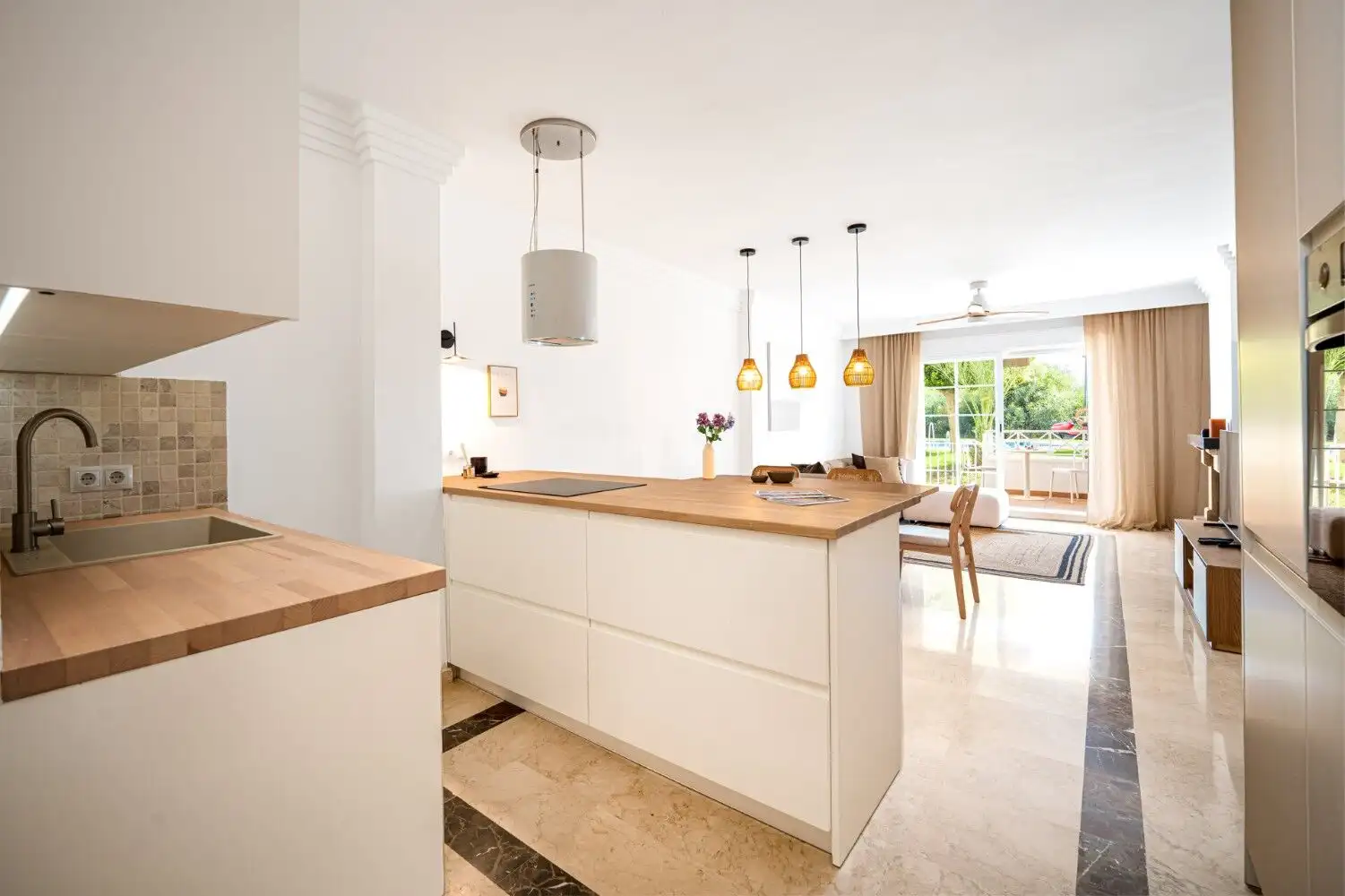Bright, renovated apartment kitchen in Marbella East with contemporary design and open-plan layout.