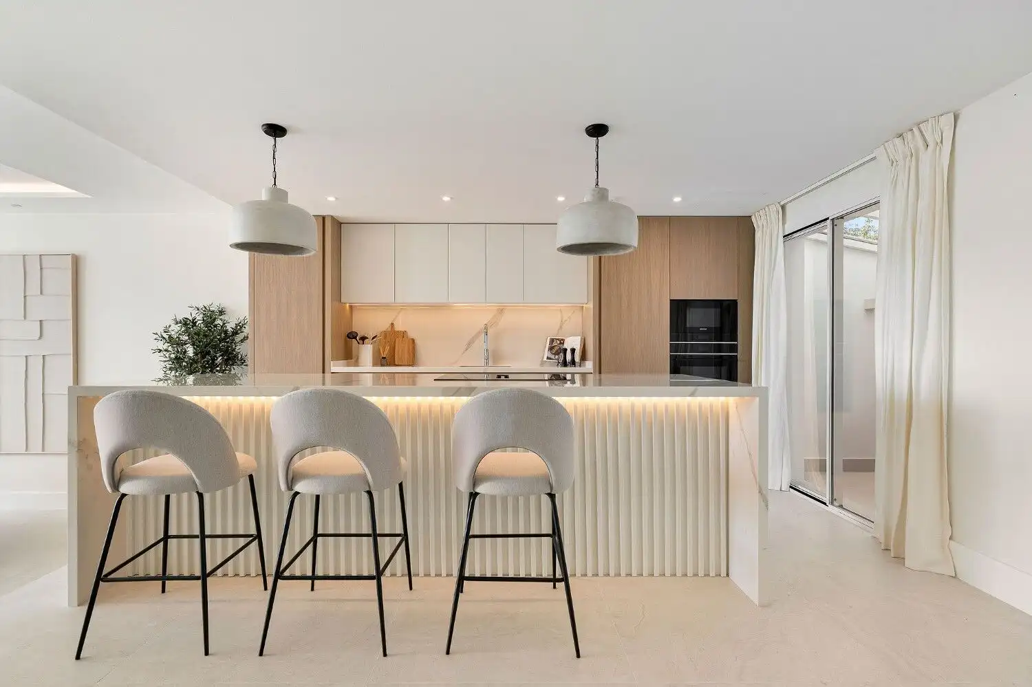 Renovated La Quinta townhouse kitchen with minimalist style and neutral color palette.