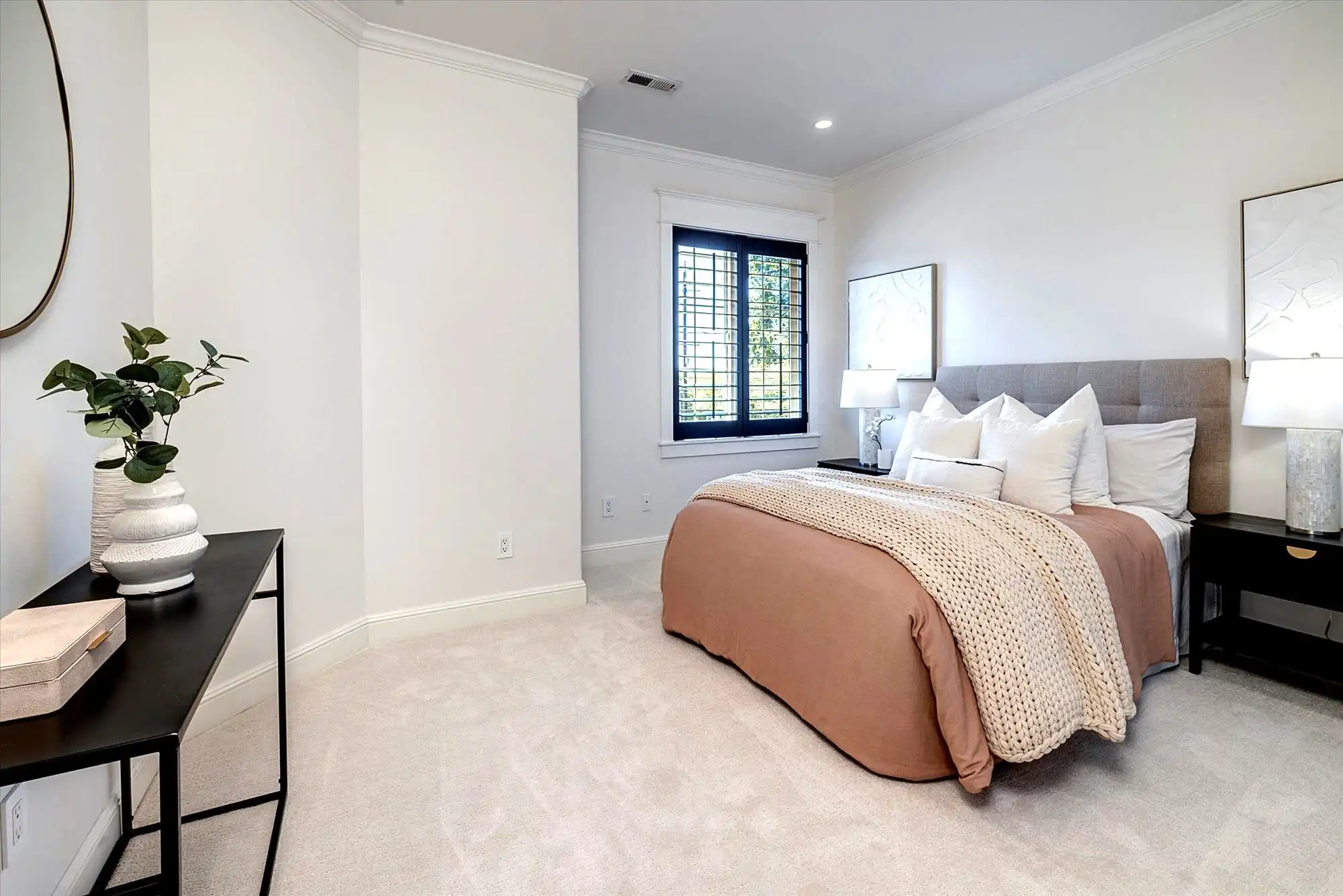 Luxury bedroom with lake views and modern decor.