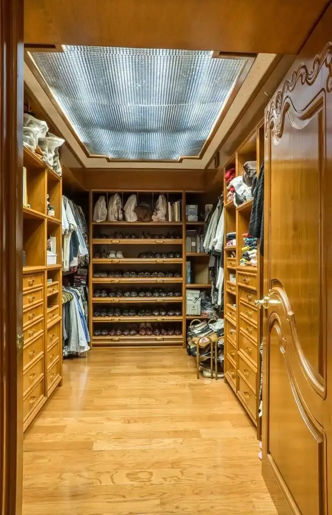 In closet in a luxury Mexico City apartment with wooden shelves and ample storage space.