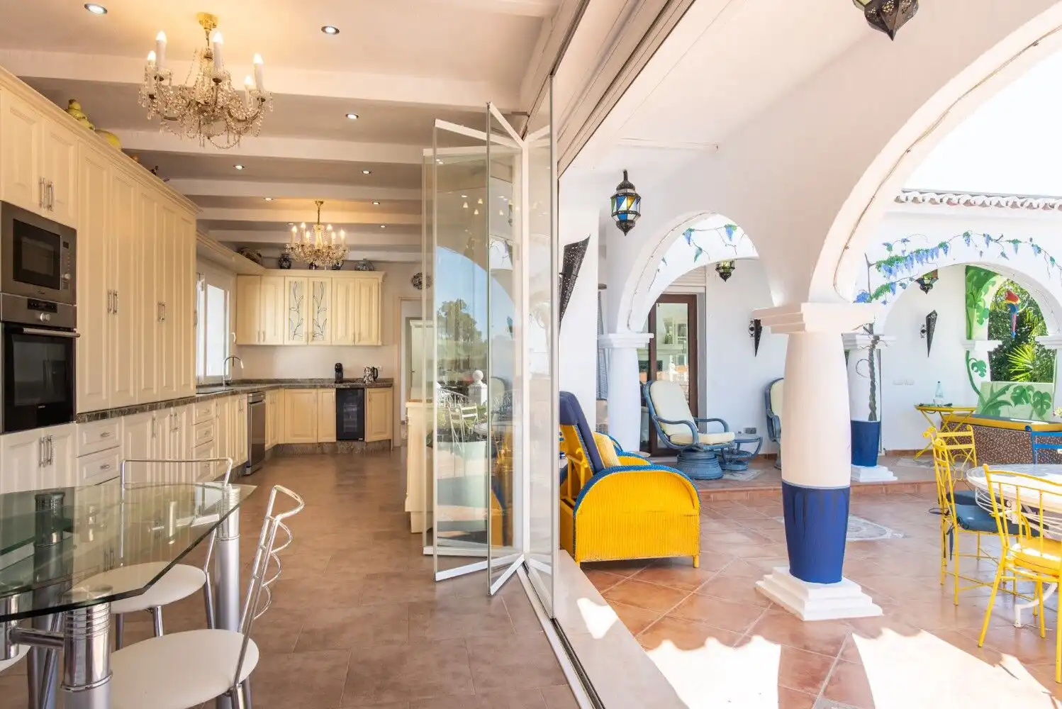 Spacious interior of Los Llanos property with elegant kitchen and bright living area, opening to a s.