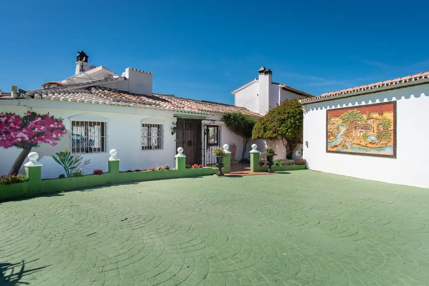 Beautiful Los Llanos estate with lush garden and traditional architecture in Estepona.