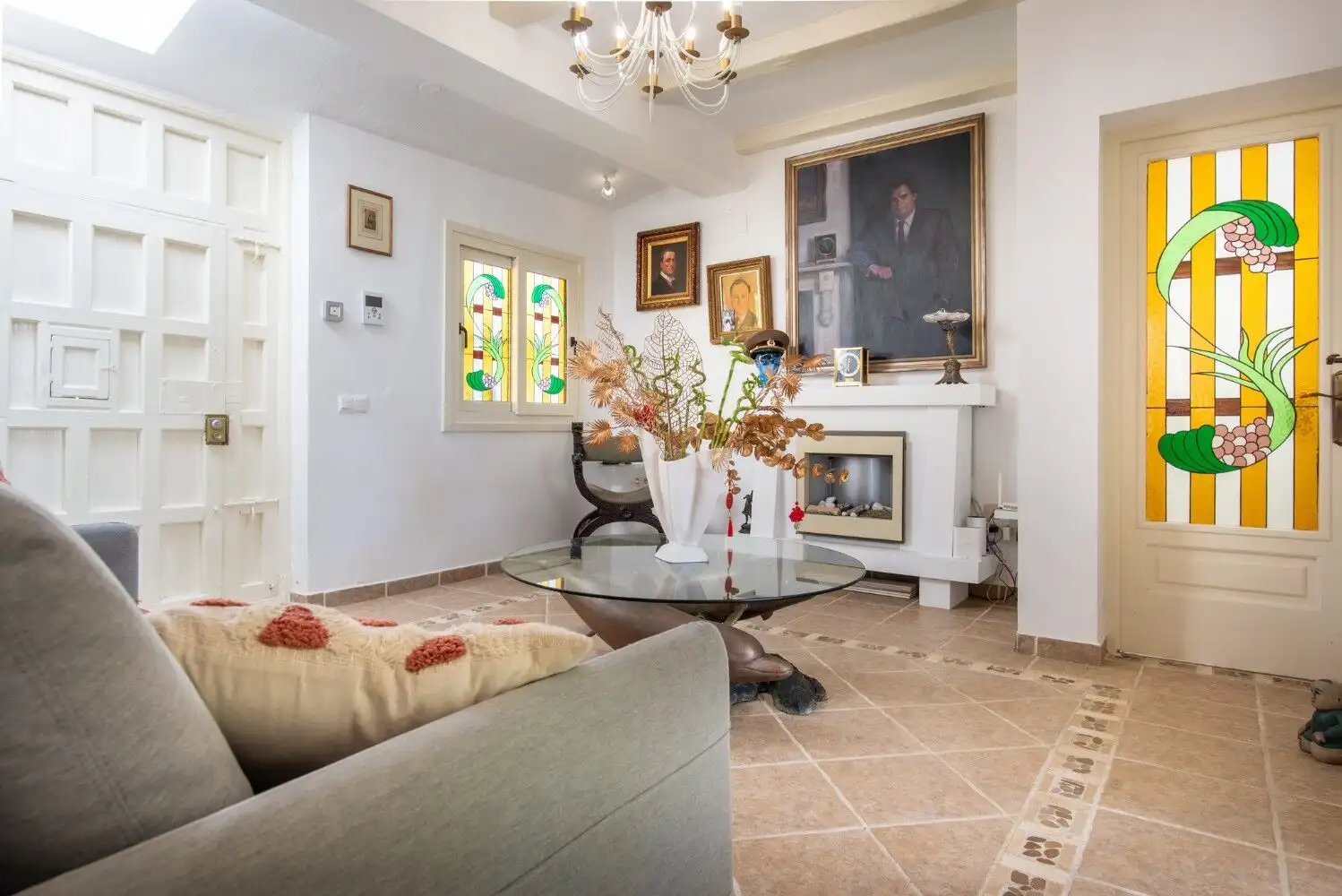 Bright living room with elegant decor in Los Llanos, Estepona, featuring artwork and colorful staine.