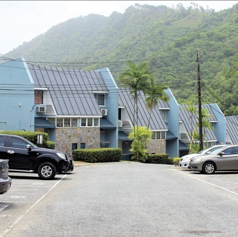 Stylish 2-bedroom townhouse for sale in Fairways Maraval, offering scenic mountain views.