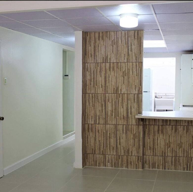Modern kitchen with wooden accents in a townhouse in Port of Spain.
