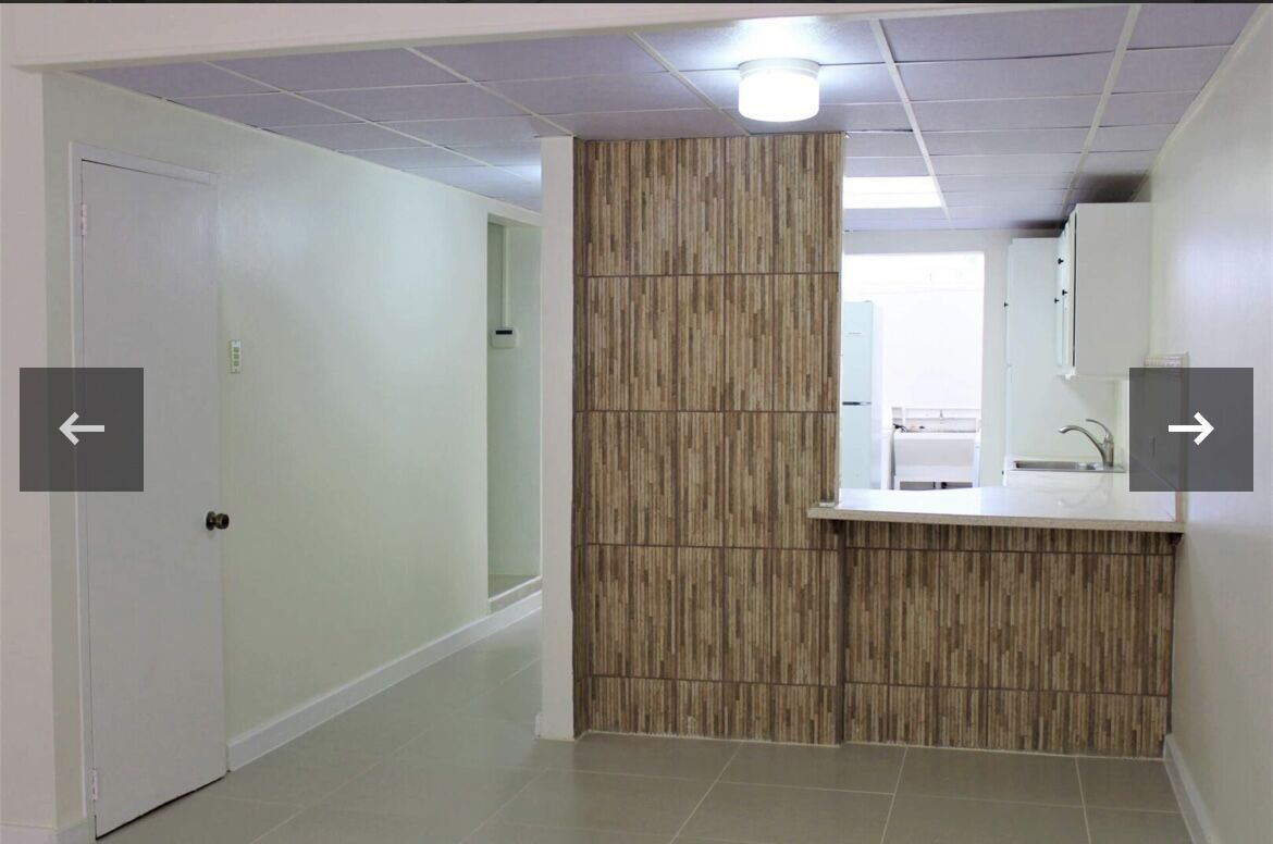 Modern kitchen with wooden accents in a townhouse in Port of Spain.