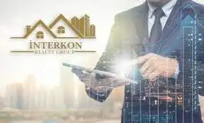 Businessman analyzing property data on tablet with digital overlay.