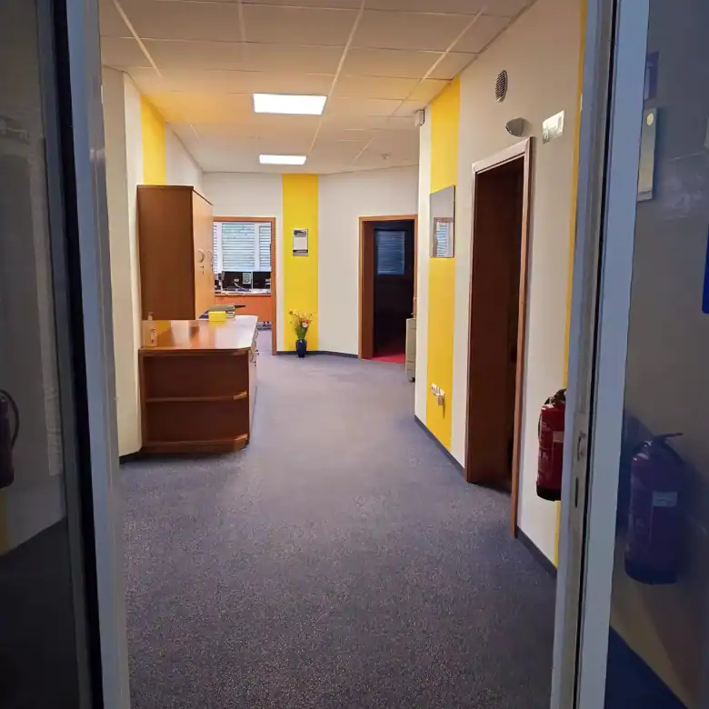 Modern office interior with bright yellow accents and functional layout in Rogatec.