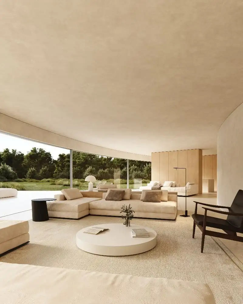 Interior view of a modern, sustainable villa with minimalist design and large windows overlooking lu.