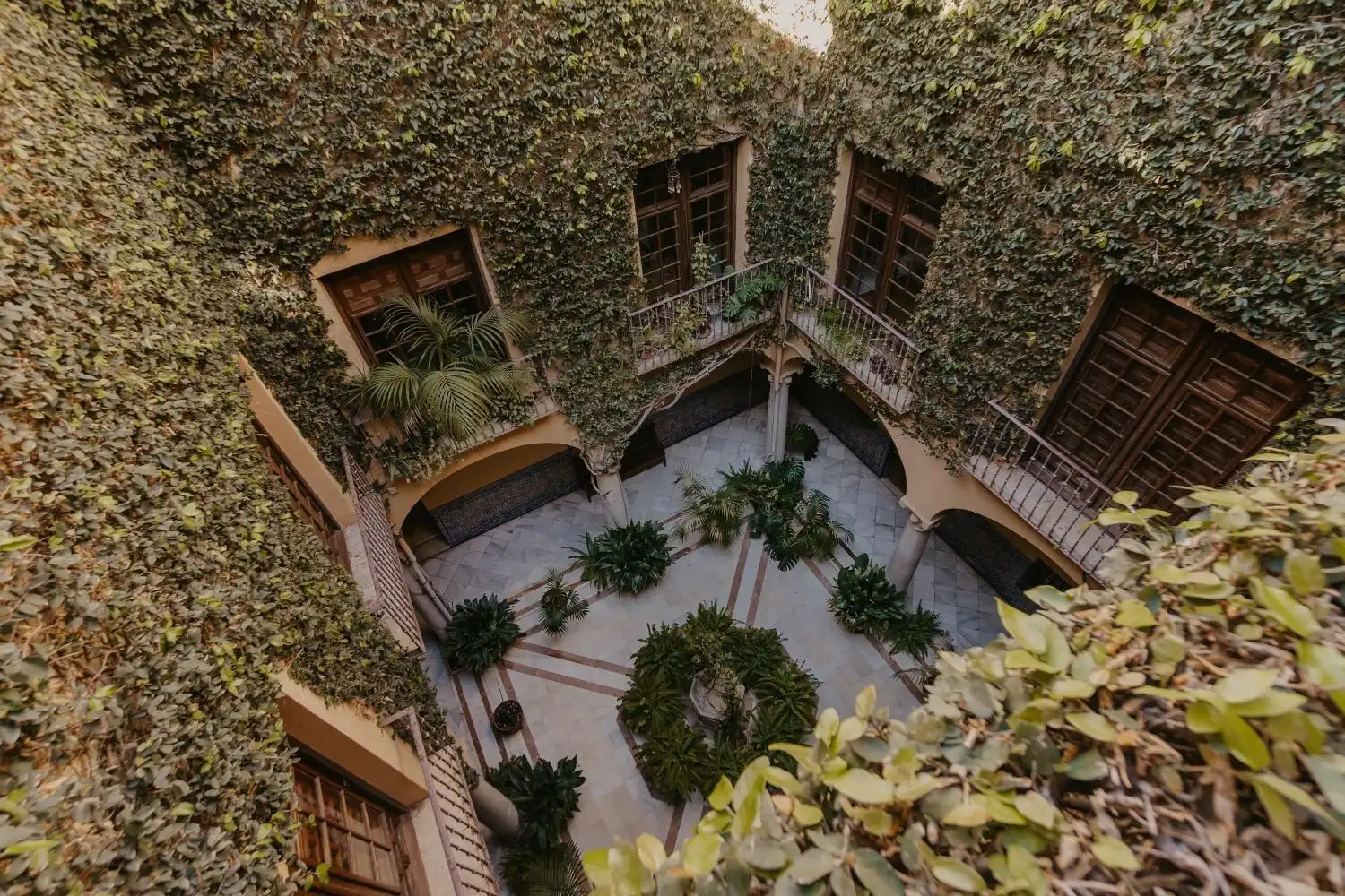 Penthouse apartment in Malaga's historic center with lush courtyard views.