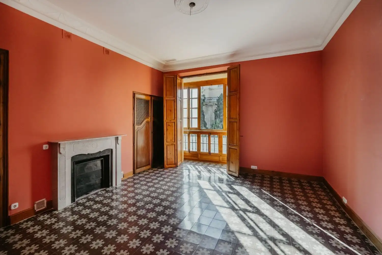Bright Malaga penthouse living room with large windows and traditional decor.