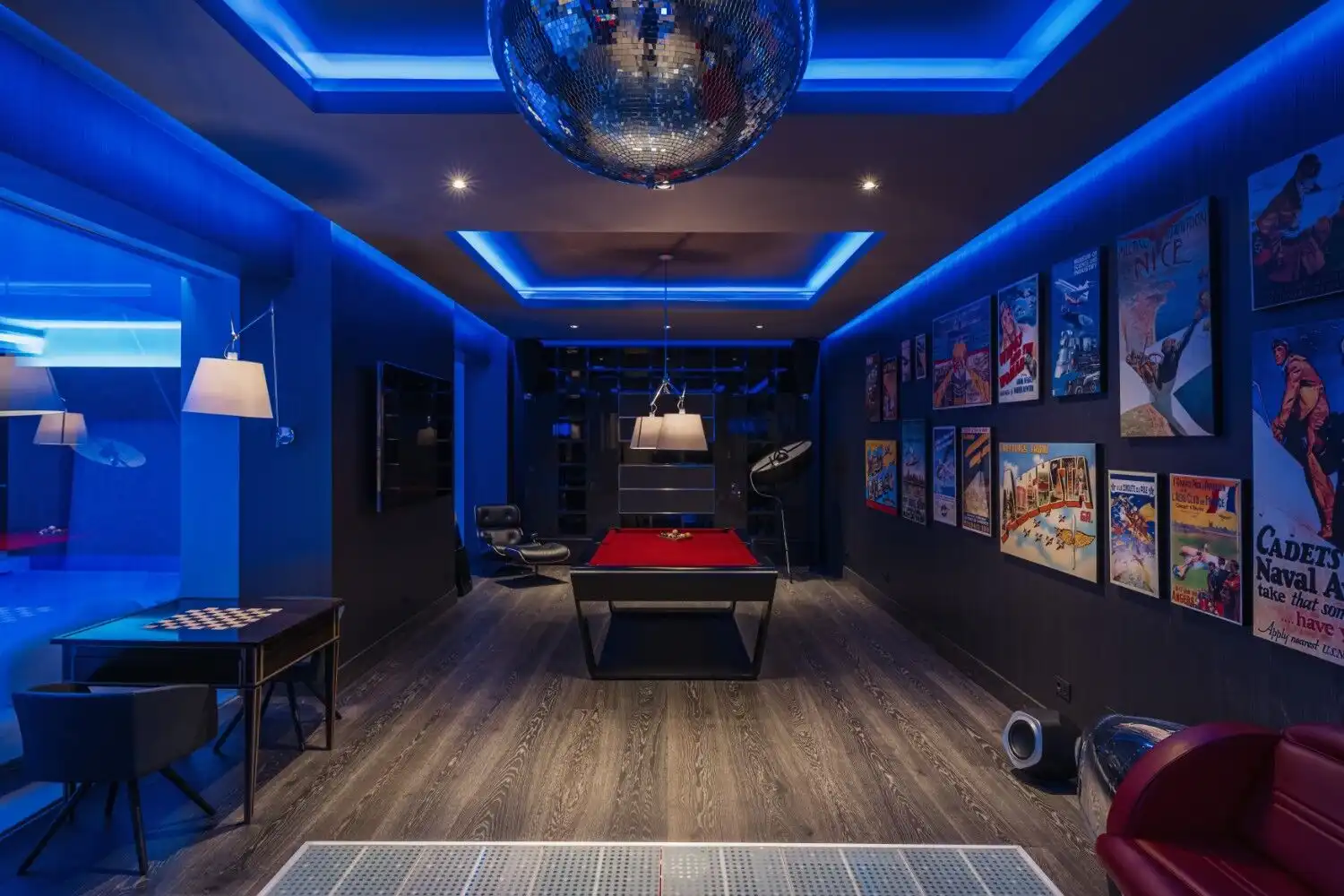 Elegant game room with vibrant blue lighting and artwork in La Zagaleta Benahavis.