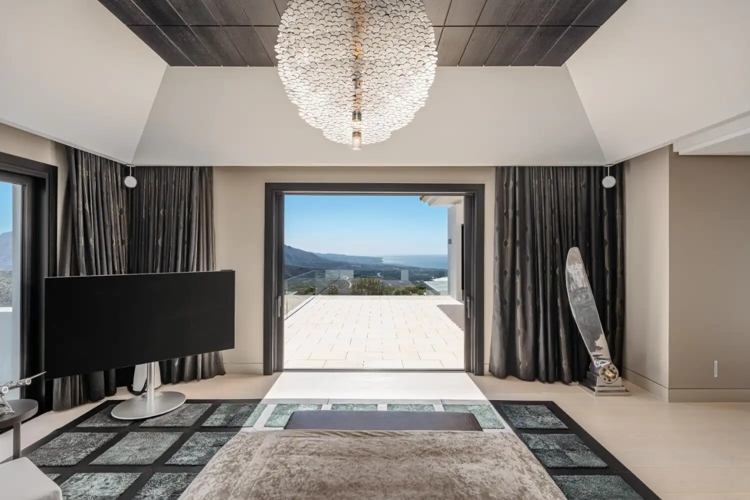 Elegant living room with large window showcasing stunning La Zagaleta Benahavis scenery.