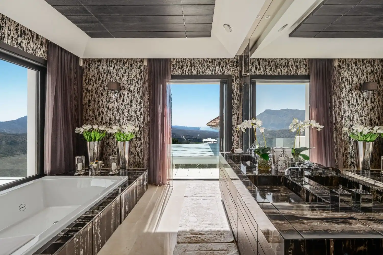 Elegant luxury bathroom featuring panoramic mountain vistas and modern design elements.