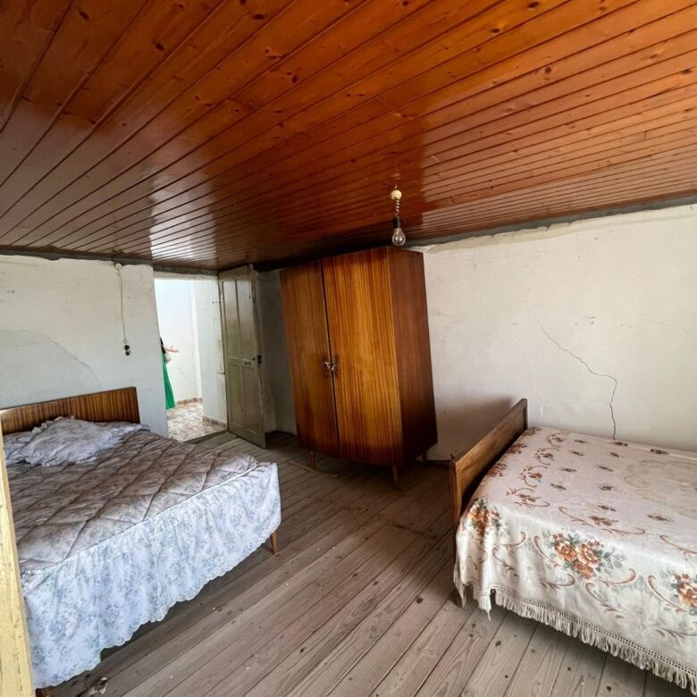 Interior view of a rustic 6-bedroom house in Taboada Galicia with wooden ceiling and simple furnishi.