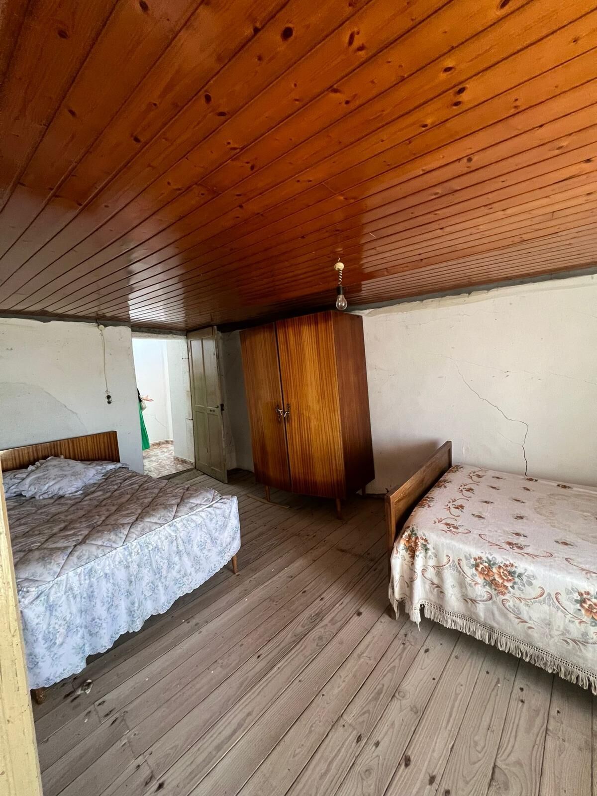 Interior view of a rustic 6-bedroom house in Taboada Galicia with wooden ceiling and simple furnishi.