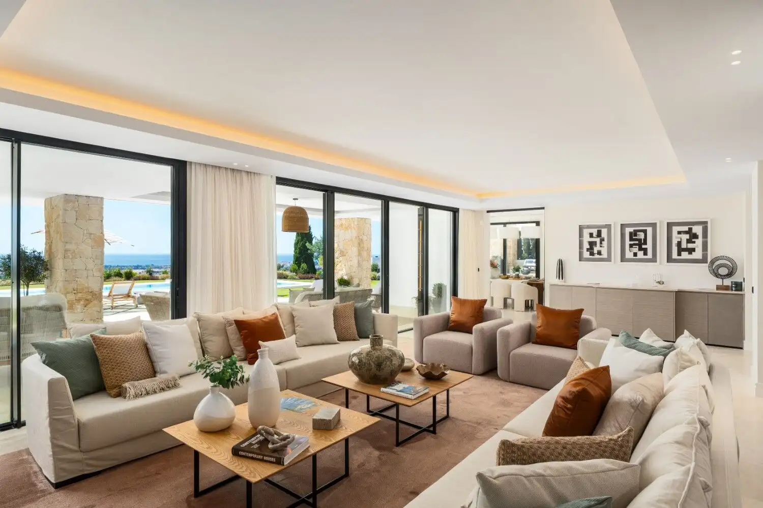 Luxury villa living room with panoramic ocean views and modern decor. Spacious, bright, and perfect.
