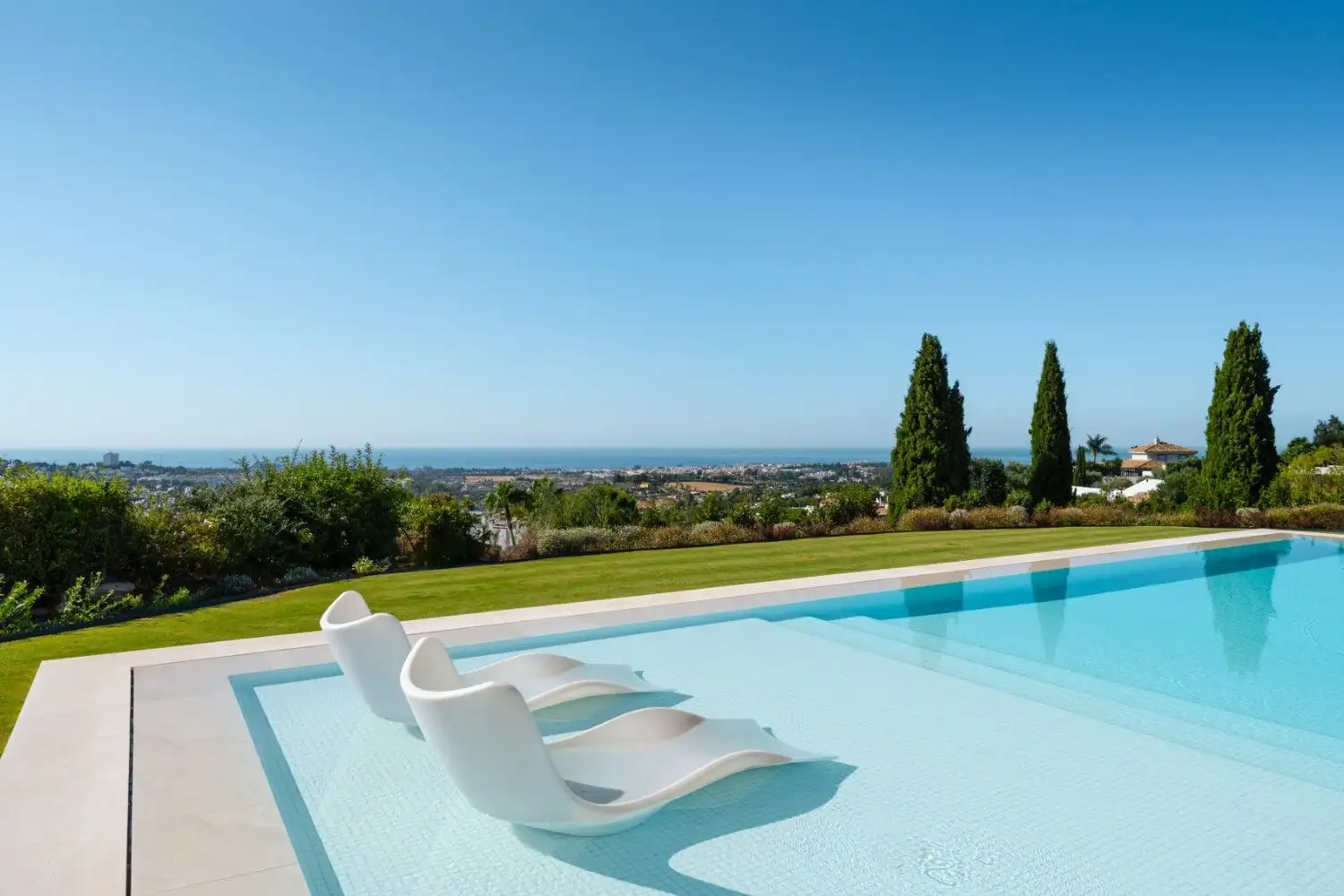 Luxury villa featuring a private pool overlooking stunning landscape and ocean views. Perfect for a.