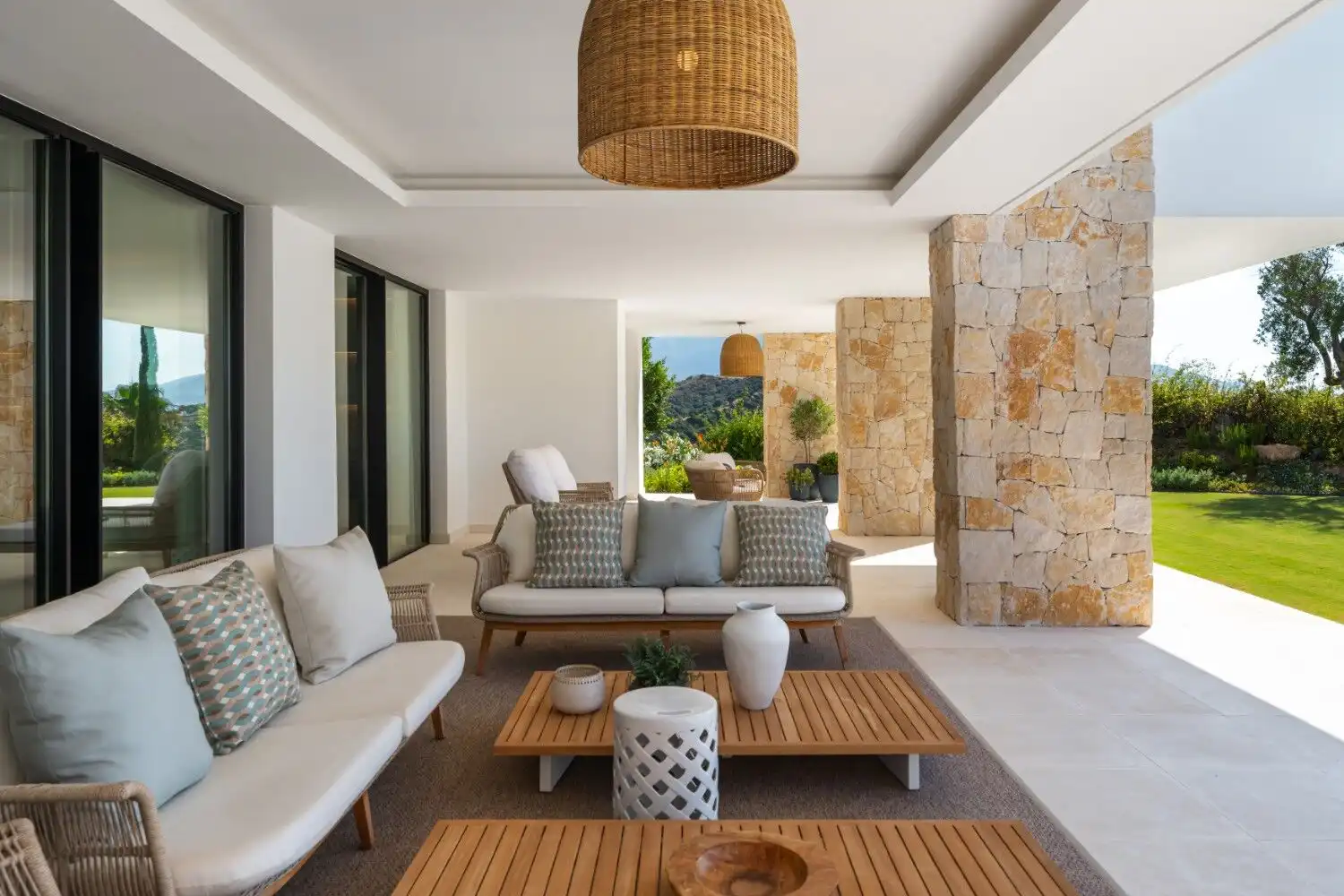 Luxury villa terrace with stylish outdoor seating and panoramic landscape views.