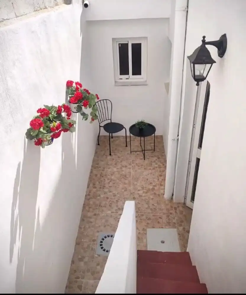 Charming outdoor patio of Torresoto casita with flowers and seating area.