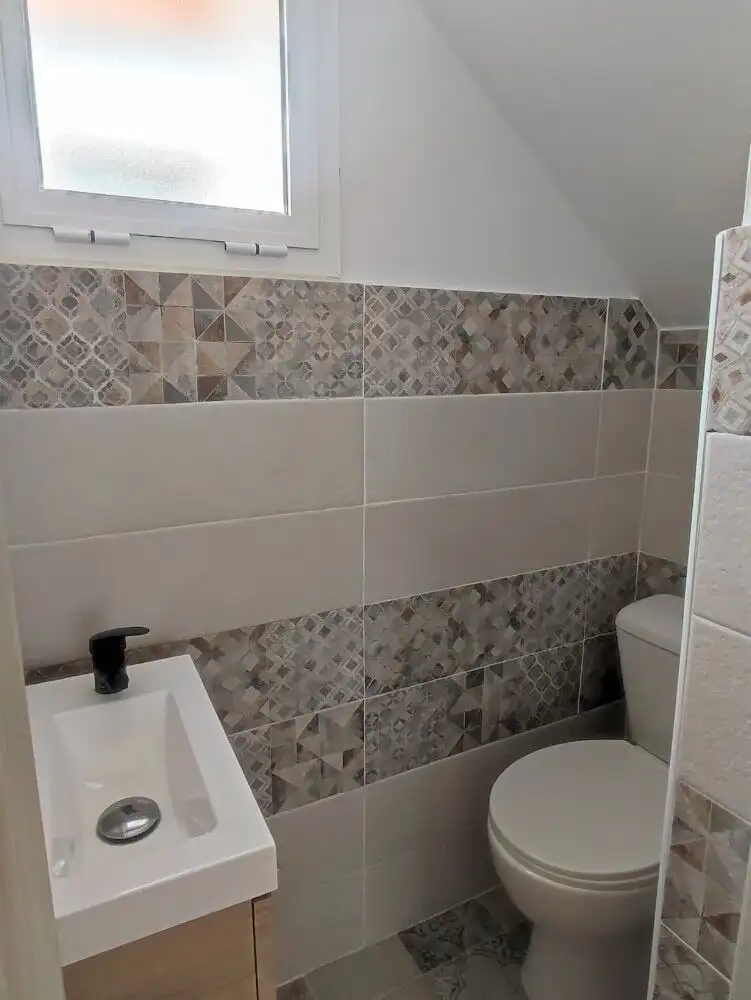 Small bathroom with patterned tiles and a compact sink in Torresoto.