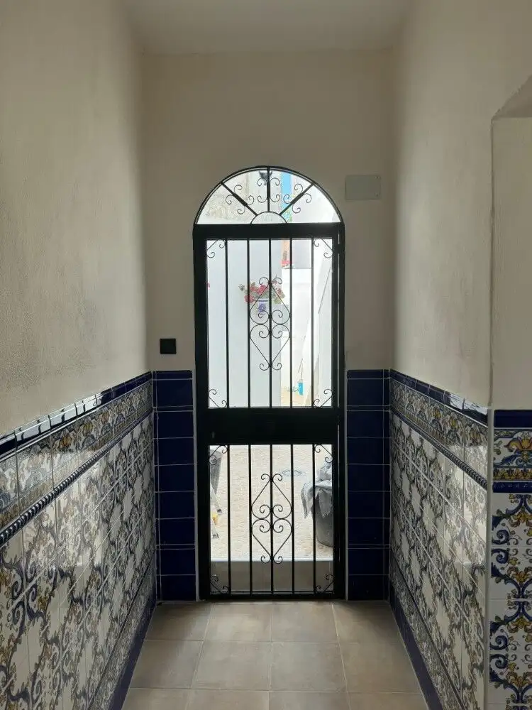 Charming entrance door with decorative ironwork in Torresoto casita.