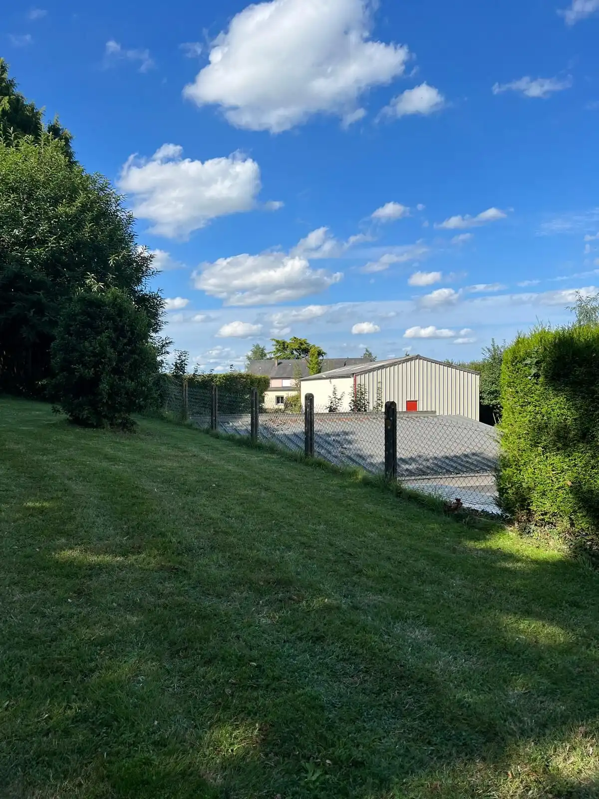 Beautiful view of a spacious property in Vautorte, Pays de la Loire, with lush greenery and a modern.