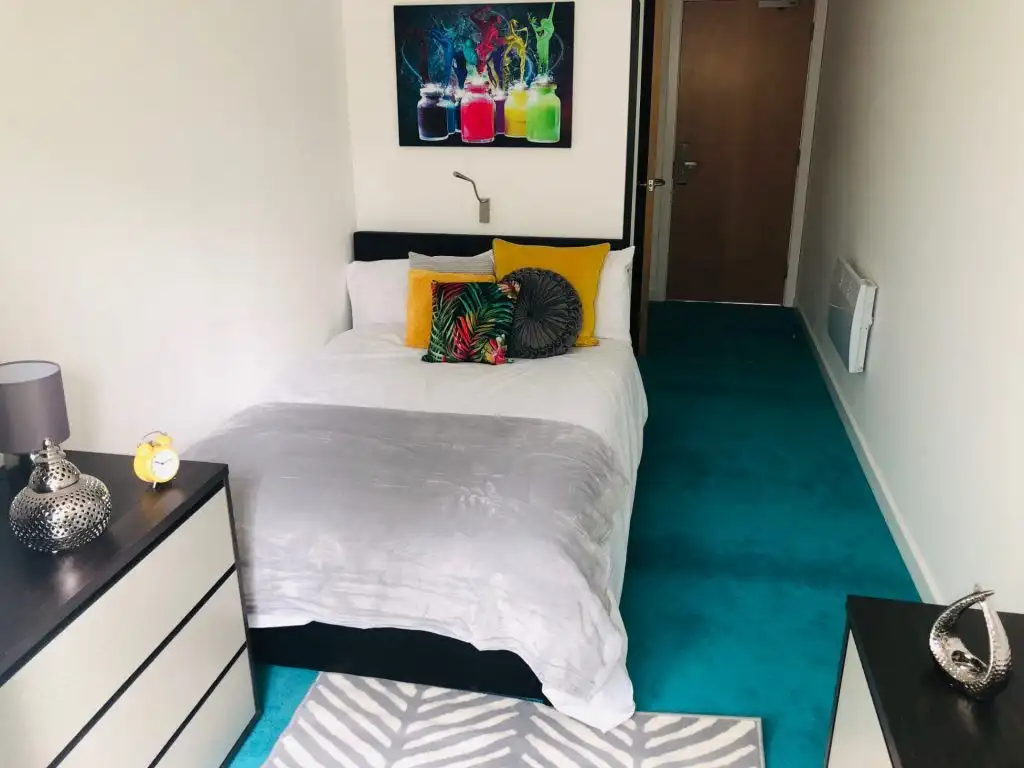 Modern student apartment in Sheffield with vibrant decor and cozy bedroom.