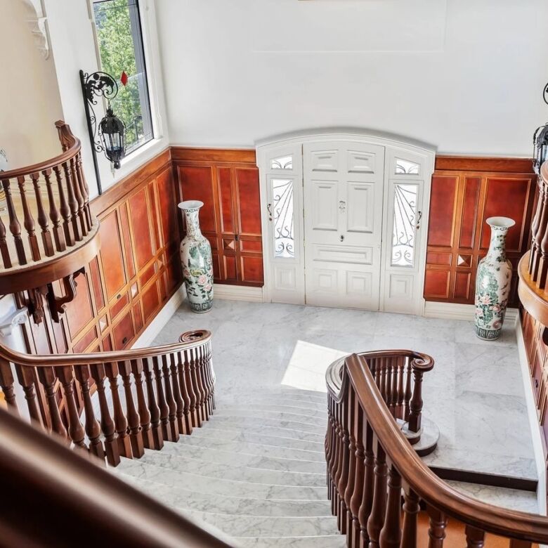 Elegant staircase and foyer of a luxury château in Ngararatunua, New Zealand.