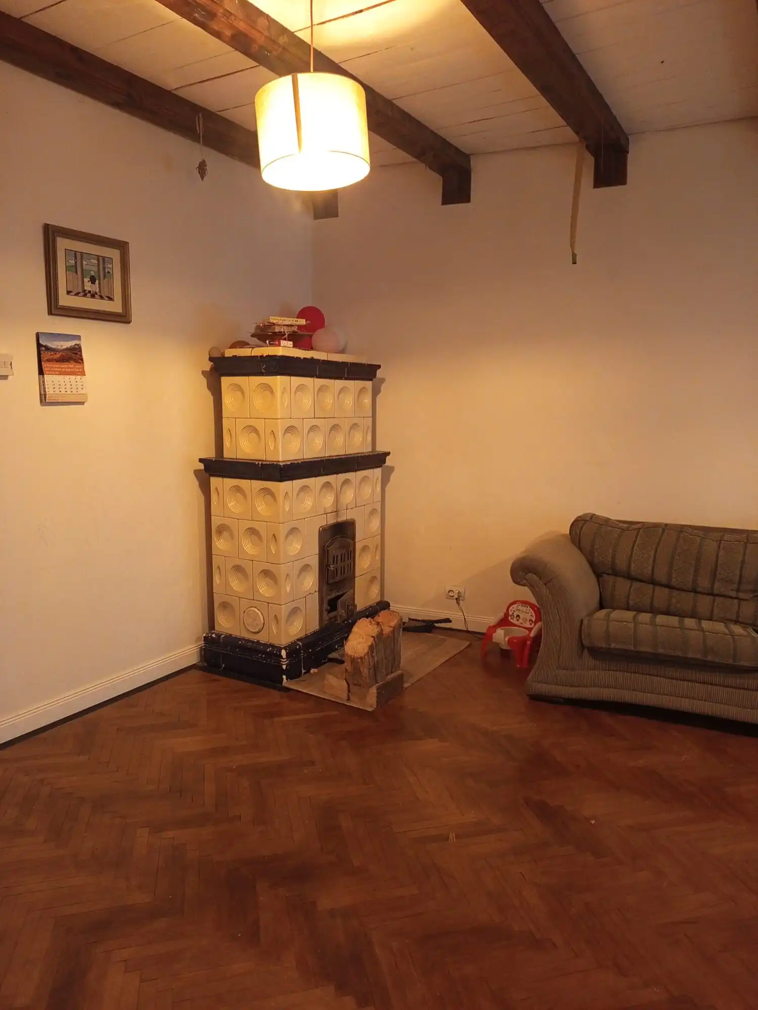 Interior of a cozy living room featuring a vintage fireplace and a comfortable sofa.