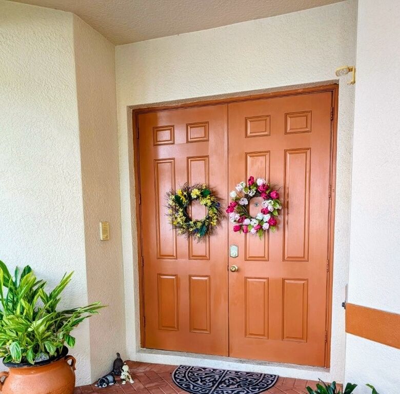 Waterfront villa entrance with floral wreaths in Cape Coral, Florida.