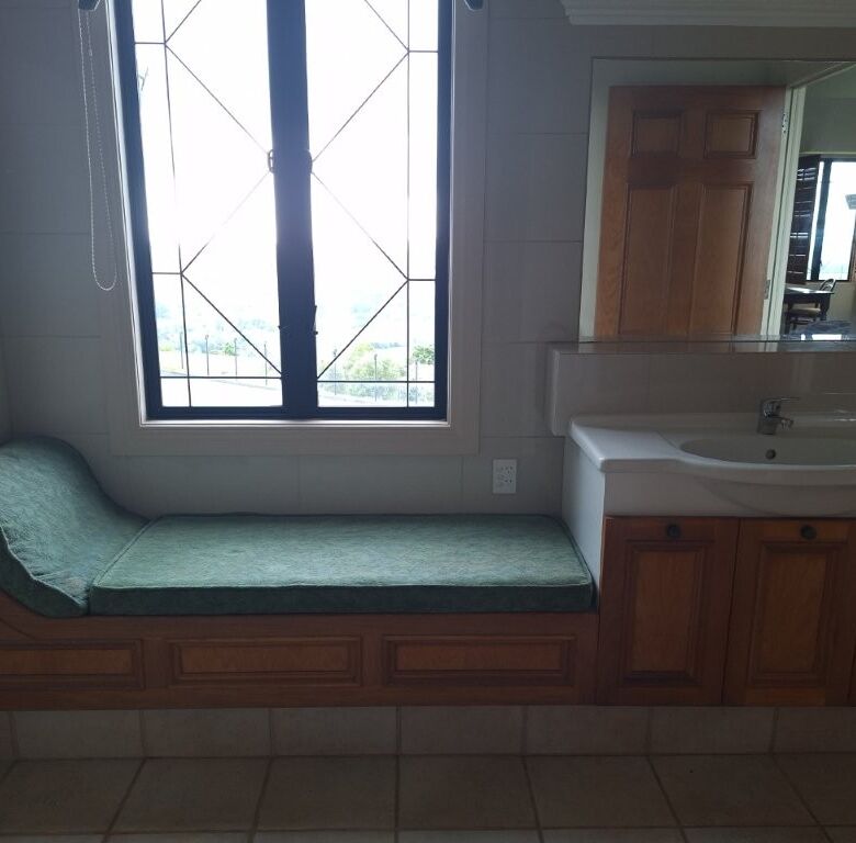 Château interior with window seat and bathroom vanity in Ngararatunua, New Zealand.