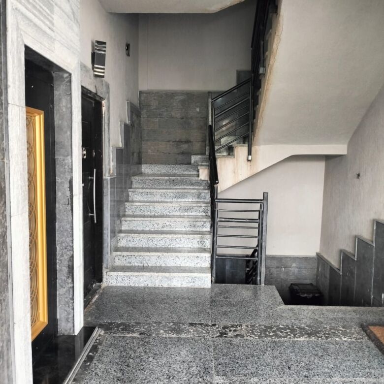 Modern staircase and lobby area in a luxury apartment building in New Cairo.