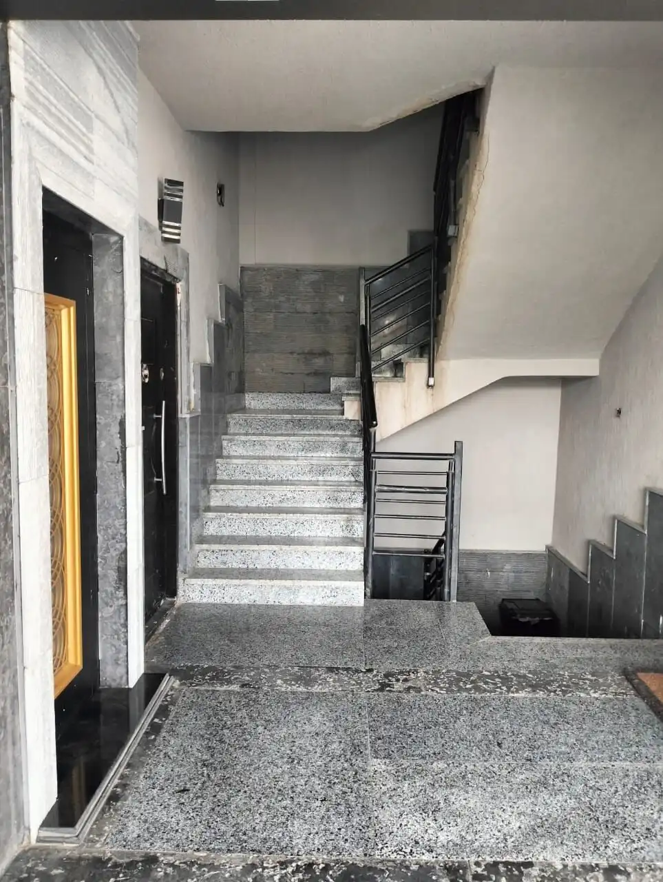 Modern staircase and lobby area in a luxury apartment building in New Cairo.