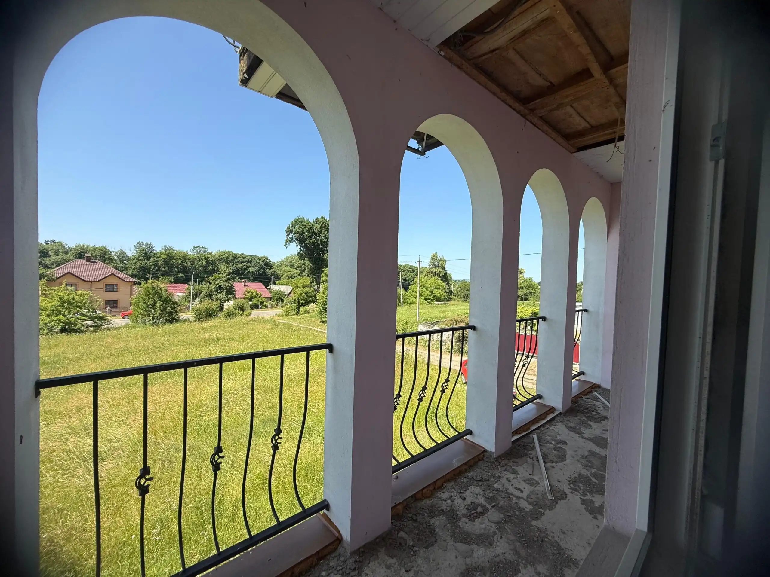 Balcony view of lush green landscape from a duplex house in Storozhynets, Ukraine.