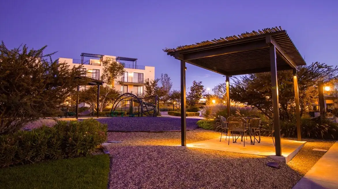Outdoor lounge area with garden, lighting, and seating at Casa Santa Elena, La Luminaria.