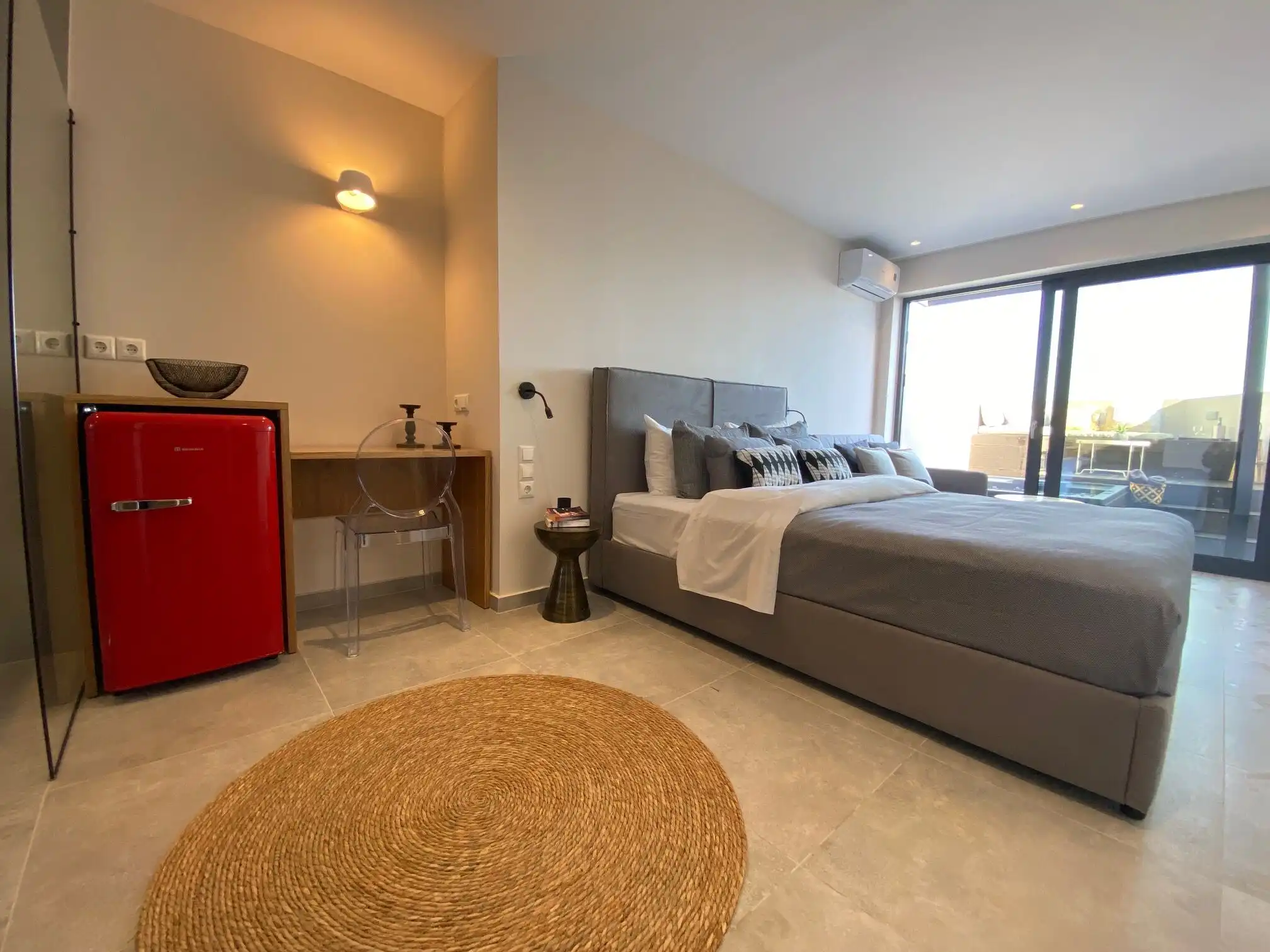 View bedroom in luxury villa with modern decor and balcony access.
