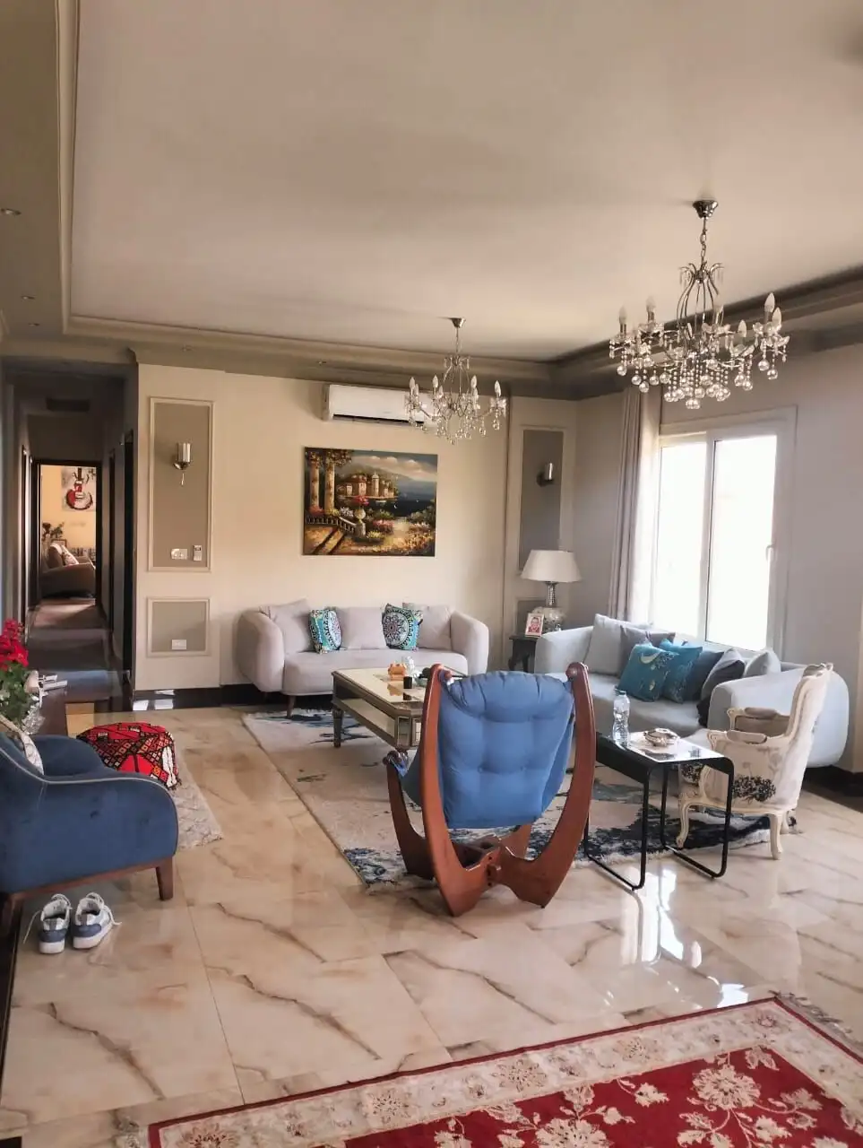 Spacious living room of a luxury 3-bedroom apartment in New Cairo, featuring elegant furniture and m.
