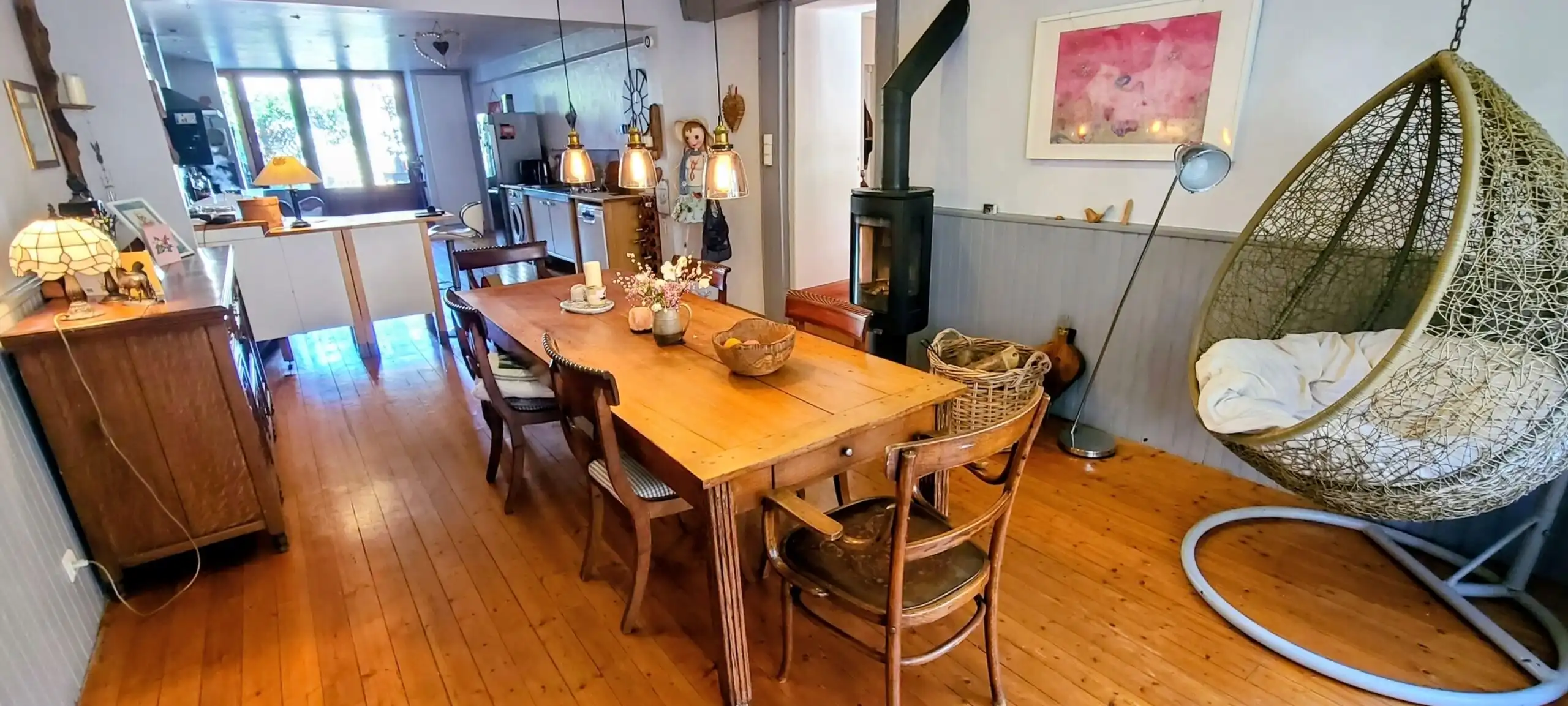 Cozy living space with wooden floors, modern lighting, and stylish decor in a beautiful Monségur tow.