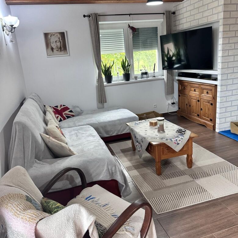 Bright living room with comfortable seating and modern entertainment setup.