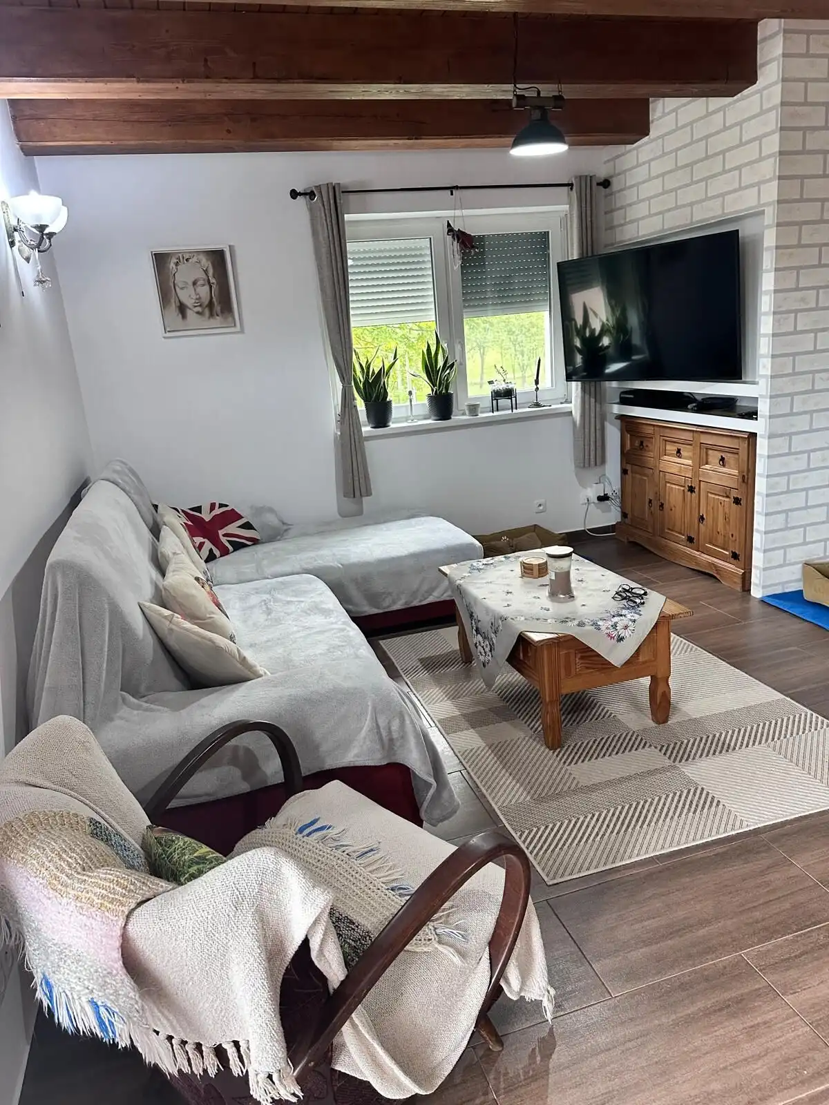 Bright living room with comfortable seating and modern entertainment setup.