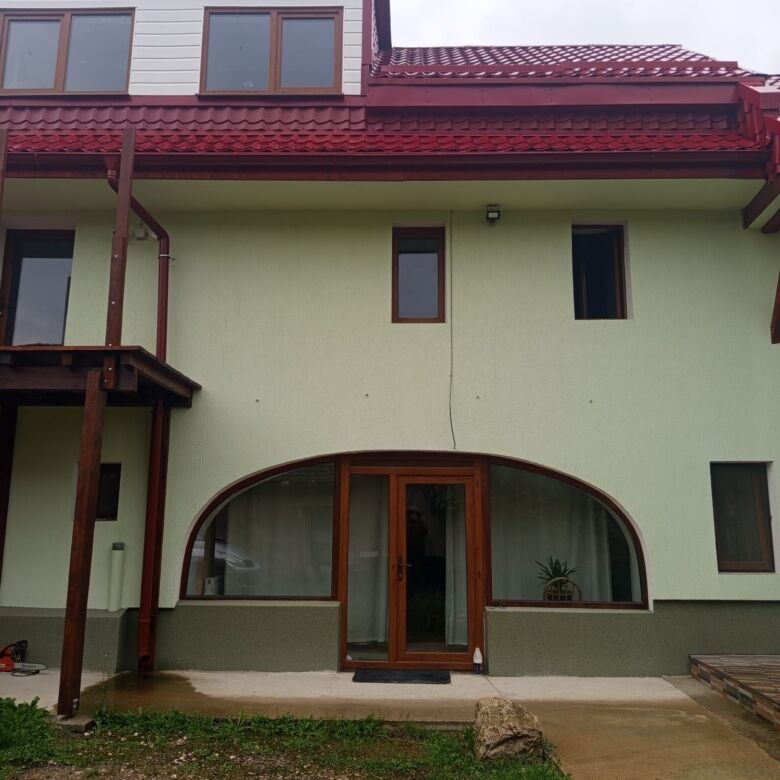 Spacious 9-bedroom house for sale in Vulcan Brasov, featuring a contemporary design and large window.