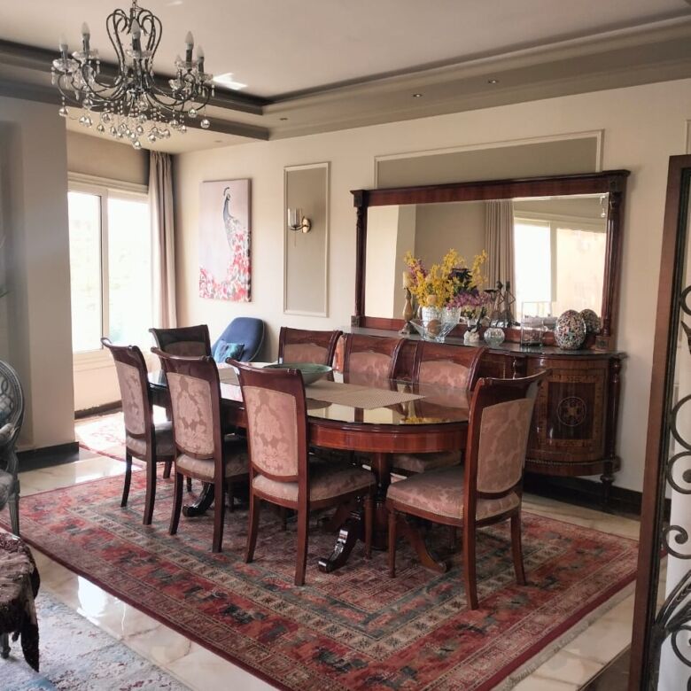 Elegant dining room in a luxury 3-bedroom apartment in New Cairo.