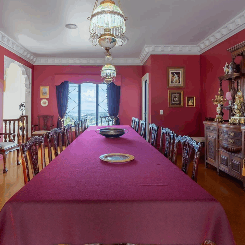 Elegant dining room in a luxury château with antique furniture and classic decor.