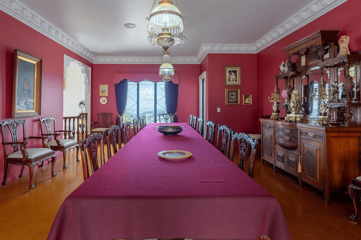 Elegant dining room in a luxury château with antique furniture and classic decor.