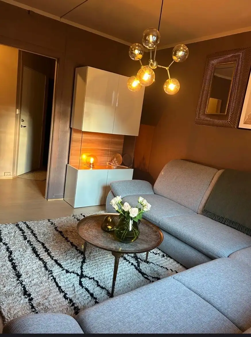 Bright living room with modern decor and stylish lighting fixtures.