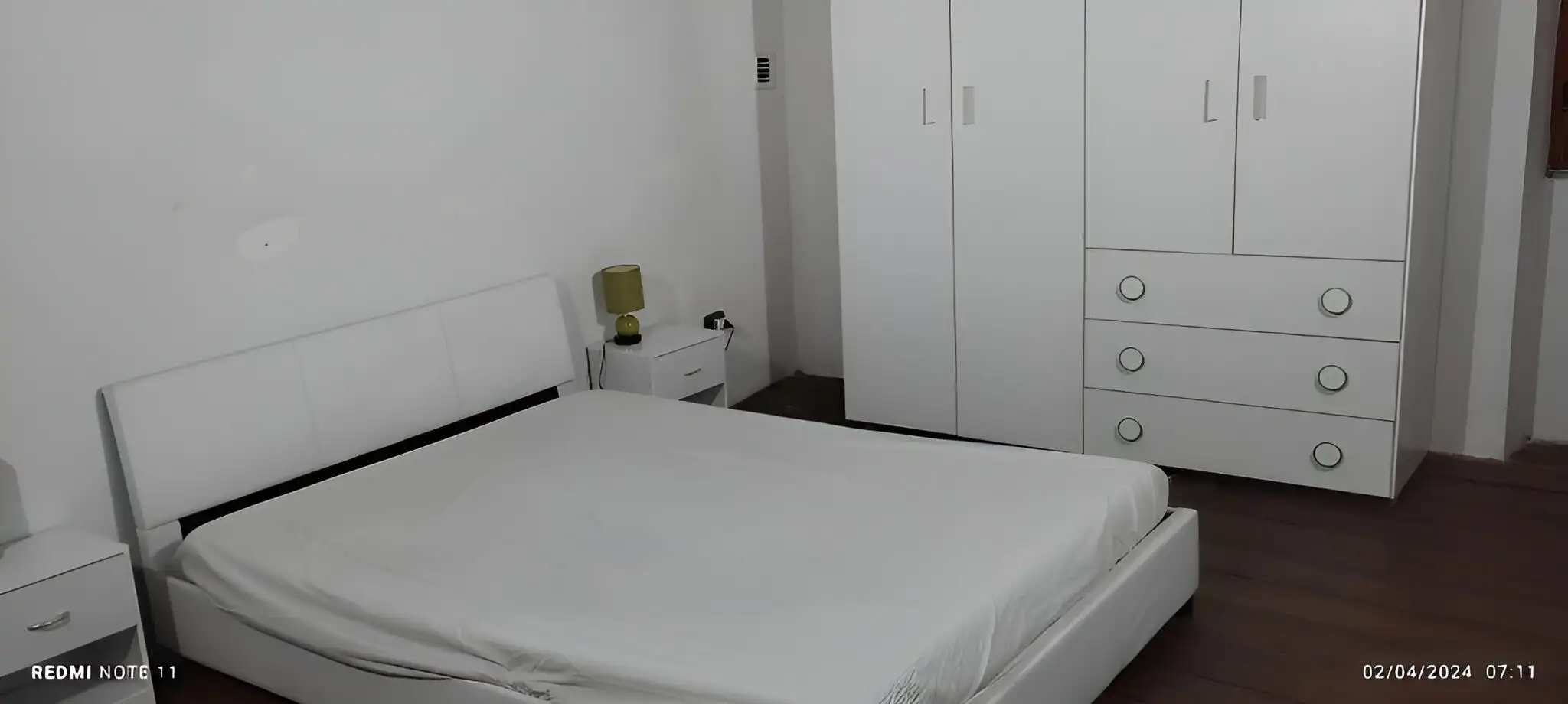 Interior view of a simple, modern bedroom in a Sardinian village apartment.